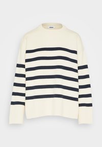 Cream sweater with navy horizontal stripes; features a ribbed neckline and cuffs; loose-fitting design with wide sleeves.
