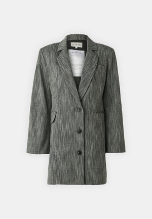 Gray striped blazer with a long silhouette, pointed lapels, front pockets, and black buttons, made from textured fabric.