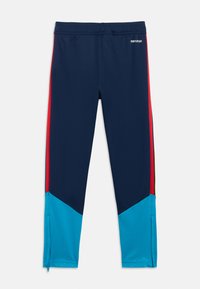 Námořnicky modré sportovní kalhoty s červeným pruhováním na boku a tyrkysovými diagonálními akcenty na lemu. Vyrobené z elastického materiálu, s elastickým pasem.