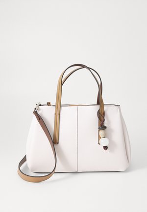 Light pink bag with textured surface, two brown handles, and a removable strap. Features decorative beads attached to a side strap.
