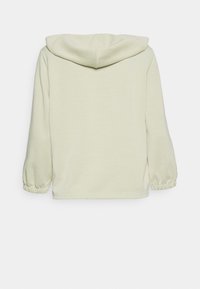 Ljusgrön hoodie med avslappnad passform, med dragsko i huvan och elastiska ärmmuddar. Tillverkad av mjukt och andningsbart material.