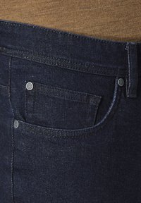 Dark denim jeans featuring a clean design, smooth texture, and metal hardware accents. Left side displays a small front pocket.