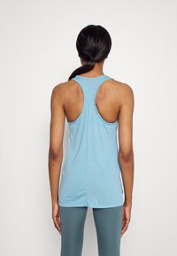 Light blue sleeveless tank top with a round neckline and racerback design. Made from a soft, breathable fabric.
