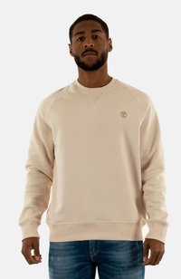 Felpa beige con collo rotondo, polsini e fondo a costine, caratterizzata da un piccolo logo ricamato sul petto. Materiale in misto cotone.