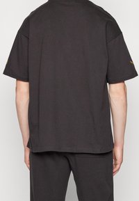 Puma Triko s potiskem - black