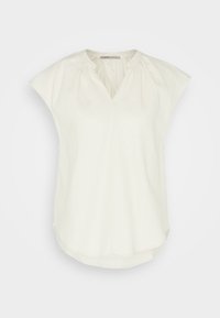 Blusa de lino blanca con escote en V, mangas cortas tipo capa y detalles fruncidos en los hombros. Dobladillo redondeado y corte relajado.