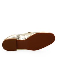 Metallic gold shoe sole with a textured, scaly pattern. Flat design with a rubber bottom in burnt orange. Size marked as 37 on the side.