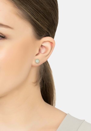 Round stud earring featuring a light blue center, surrounded by a silver-colored decorative border. Smooth finish and small size.