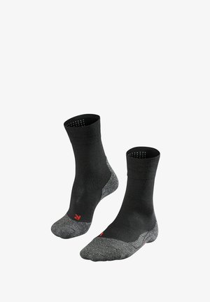 Chaussettes noires mi-mollet avec un embout et un talon gris texturé, un soutien de voûte plantaire renforcé et des détails en rouge près du rebord.
