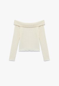 Vaate päältä olkapäiden päältä avautuva vaalea toppi, joka on valmistettu teksturoidusta kankaasta ja jossa on pitkät hihat sekä aallotettu helma.