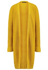 Cárdigan largo de punto en un amarillo brillante con apertura frontal, mangas acanaladas y tejido texturizado para proporcionar calor. Destacado por su corte holgado.