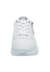 White sneaker with white laces, silver logo on tongue, and side zipper, shown from front on a white background.