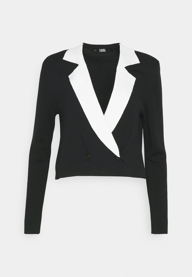 Schwarze, verkürzte Jacke mit weißem Schalkragen, langen Ärmeln, zwei schwarzen Knöpfen und einer glatten Stricktextur. Geeignet für formelle oder semi-formelle Anlässe.