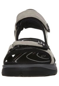 Light grey adjustable sandal with black straps and textured footbed. Features a cushioned sole, Velcro closures, and a contoured design.
