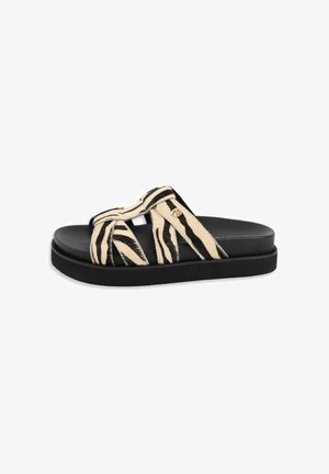 Black slide sandal with thick sole featuring beige and black zebra-striped crisscross straps and a small gold brand emblem.