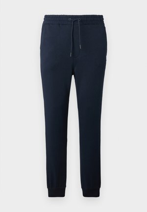 Pantaloni della tuta blu navy in tessuto morbido, dotati di una vita elasticizzata con coulisse, gambe affusolate e polsini aderenti alle caviglie.