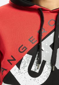 Red and black hoodie with a textured fabric, featuring a graphic design in silver, a drawstring hood, and bold printed text.