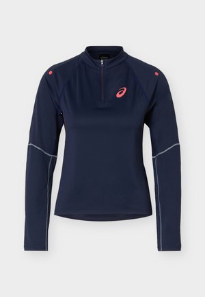 Haut de sport manches longues bleu marine avec une fermeture éclair quart, logo ASICS rose sur la poitrine et petits points roses sur les épaules.