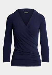Marinblå långärmad omslagstopp i mjukt, stretchigt material. Har en djup V-halsringning och rundade sömmar för en figurnära silhuett.