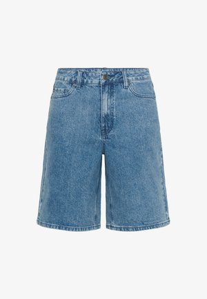 Trapke od traper tkanine svijetloplave boje s ravnim krojem, pet džepova i metalnim kopčanjem na gumb. Prednji dio ima izlizanu teksturu.