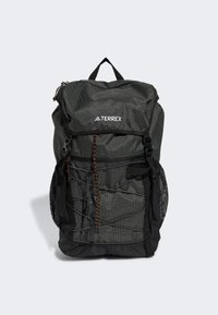 Black mesh backpack with orange accents and a grid pattern. Features adjustable straps, a top handle, and multiple exterior pockets.