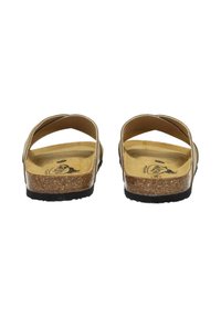 Tan cork footbed sandals with black rubber soles, featuring an open-back design and crisscross straps. Subtle logo detail on footbed.