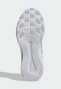 White sneaker sole with textured rubber, featuring a grid pattern and concentric circular grooves. Includes branding in the center.