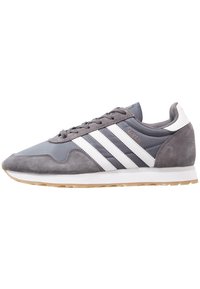 Gray Adidas Haven sneaker with white stripes, suede toe and heel, mesh upper, white sole, and gum outsole, shown in profile view.