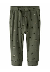 Ribbade, olivgröna joggers med dragsko i midjan. Har små traktor mönster i svart och beige genomgående. Mudd i bensluten.