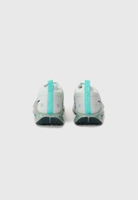 Light green athletic shoes with a textured mesh upper, padded heel, turquoise accents, and speckled grey rubber sole.