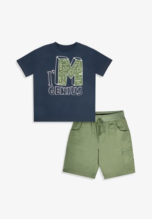 T-shirt bleu marine à manches courtes avec le texte « I'm Genius » et des motifs sur le thème de la science, associé à un short vert olive à cordon avec poches.