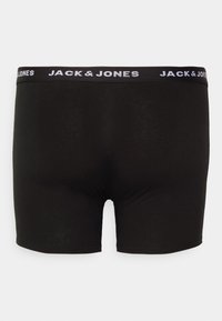 Schwarze Baumwoll-Boxershorts mit glatter Textur, ausgestattet mit einem schwarzen Bund mit dem "JACK & JONES"-Logo in Weiß. Einfaches Design, mittellange Schnittform.