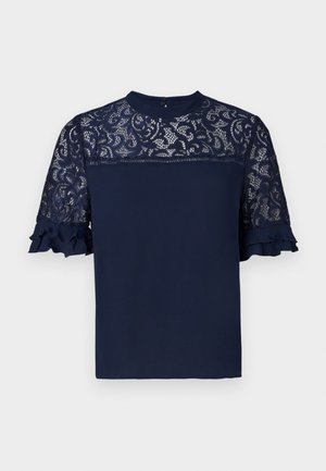 Blusa navy con maniche in pizzo e orlo arricciato. Tessuto morbido, scollatura a girocollo e motivo in pizzo intricato su spalle e maniche.