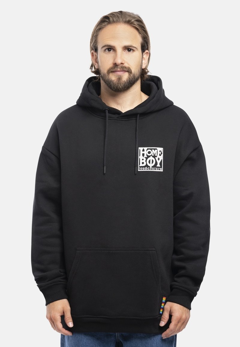 Felpa nera con cappuccio realizzata in misto cotone, dotata di stringhe di regolazione e tasca frontale. Presenta un logo grafico bianco sul petto e un accento arcobaleno sull'orlo.