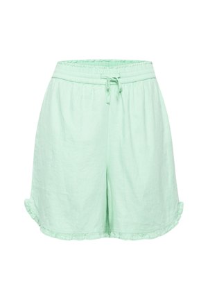 Pantalones cortos de lino verde claro con cinturilla elástica, cordón y dobladillo volado. Diseño simple sin bolsillos ni adornos adicionales.
