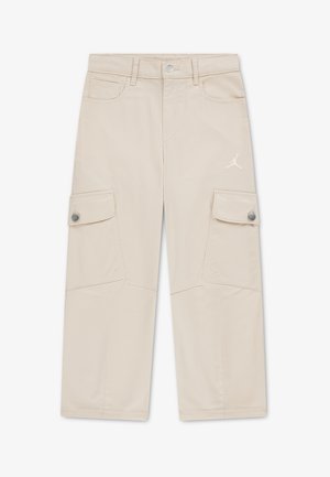 Pantalon cargo beige clair avec poches à rabat boutonnées sur chaque jambe, poches avant, passants pour ceinture et petit logo Jumpman sur la cuisse droite.