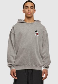 Gray pullover hoodie made of soft cotton blend, featuring a front pocket, ribbed cuffs, and an embroidered Mickey Mouse design on the chest.