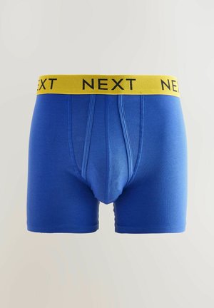Blaue Boxershorts aus einem Baumwollmix mit einem gelben elastischen Bund, auf dem "NEXT" in Schwarz gedruckt ist. Glatte Textur und taillierter Schnitt.