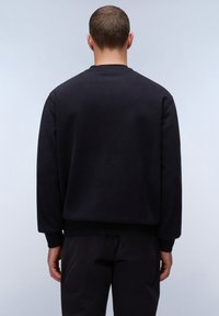 Zwarte crew neck sweatshirt, katoen stof, ribgebreide mouwen en zoom, losse pasvorm, gladde textuur, effen achterkant.