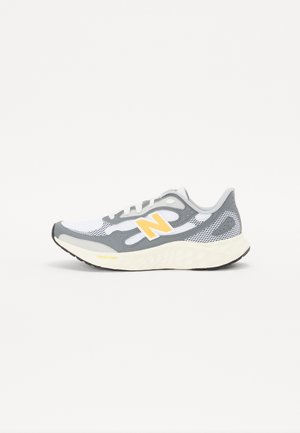 Gray and white running shoe with mesh upper, yellow accents, and a lightweight sole featuring textured tread for grip.