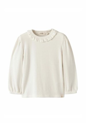 Chemise crème à manches longues en maille côtelée pour tout-petit, col à volants et poignets élastiques, étiquetée Lil’ Atelier, devant uni, texture douce du tissu.