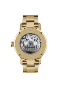 Montre automatique en acier inoxydable doré avec un fond de boîte transparent révélant les mécanismes intérieurs, des accents bleus et un bracelet en métal brossé.