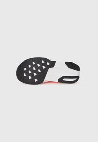 Sports shoe outsole featuring a lateral black rubber section with a textured grip pattern, a white midsole with sculpted detailing, and bright orange accents.