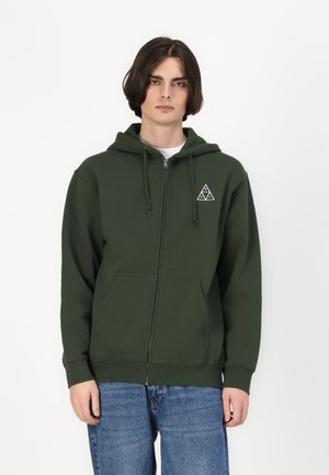 Dark green zip-up hoodie made of soft fabric, featuring a front pocket, tonal drawstring, and a white triangular logo on the left chest.