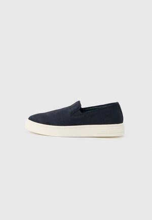 Navy blue slip-on sneaker with white rubber sole, low profile, and minimal stitching detail on smooth upper.
