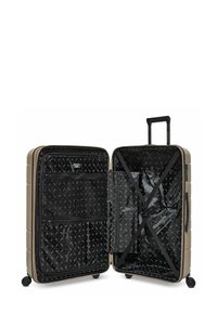 Valigia rigida di colore beige con una superficie testurizzata. L'interno presenta un tessuto nero, numerose tasche con zip e cinghie incrociate per un'organizzazione ottimale.