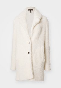 Cream-colored, textured plush coat with a notched collar, two buttons, and side pockets, featuring a soft interior lining.