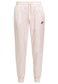 Ljusrosa satin-joggers med elastisk midja och snörning. Har svart Nike Air-logotyp på vänster lår och elastiska muddar.