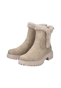 Bottines en suede beige avec un doux revers en fausse fourrure, des coutures marquées et une semelle en caoutchouc épaisse dotée de motifs de traction.