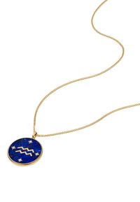 Collana placcata in oro con un pendente rotondo blu che presenta un simbolo ondulato e accenti a stella, con una texture liscia e una finitura lucida.